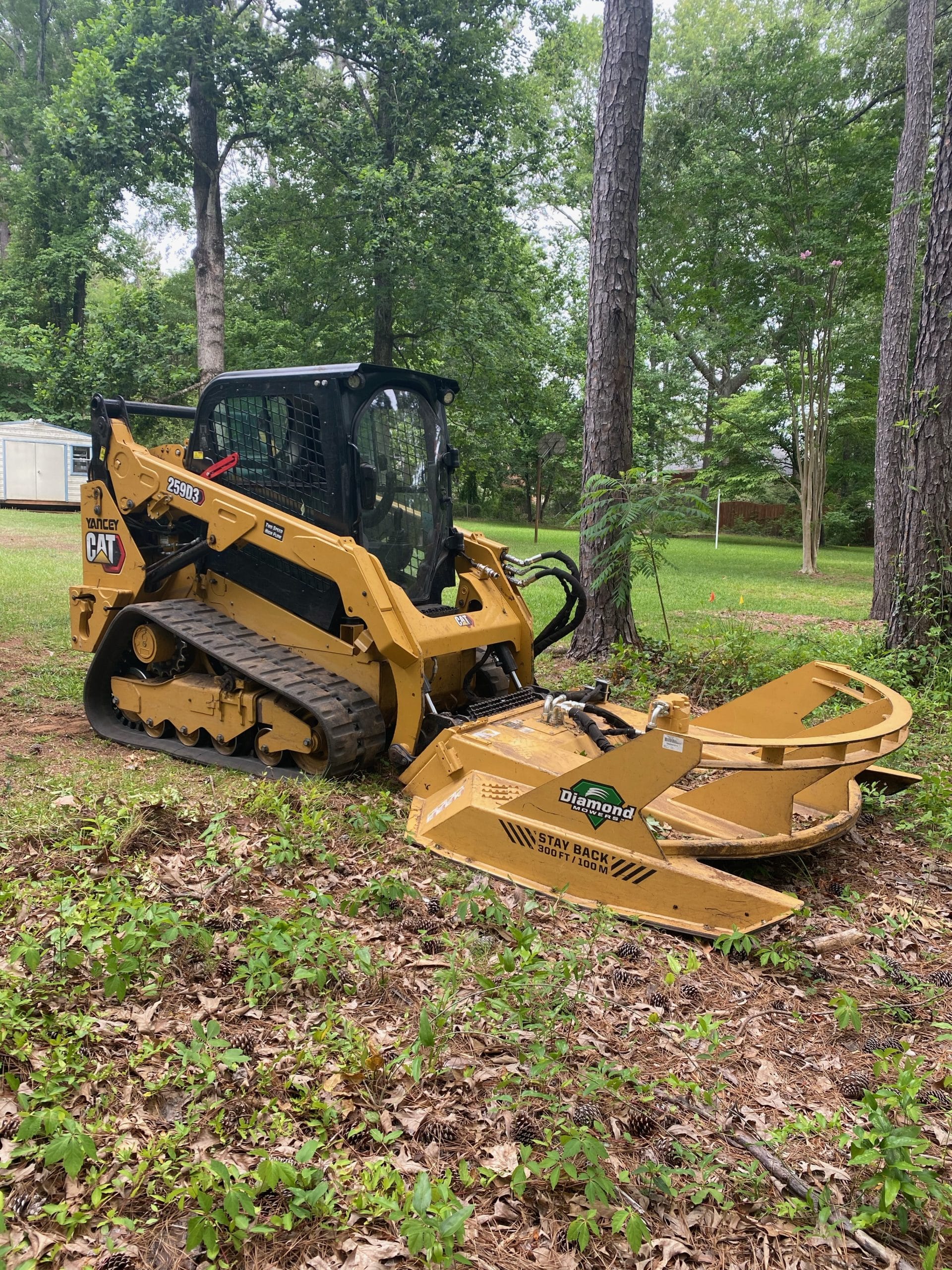 Skid steer with brush cutting attachment