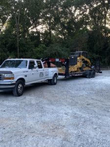 truck pulling skid steer