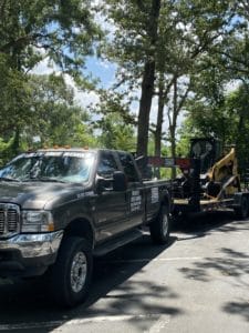 skid steer being transported on a trailer